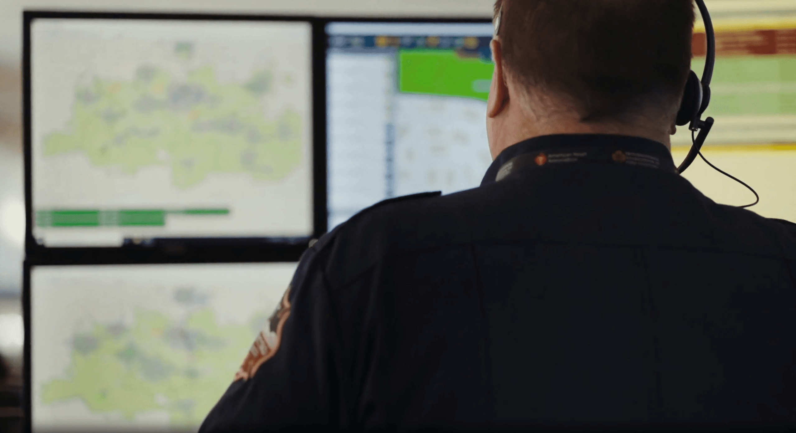 911 dispatcher looking at several screens